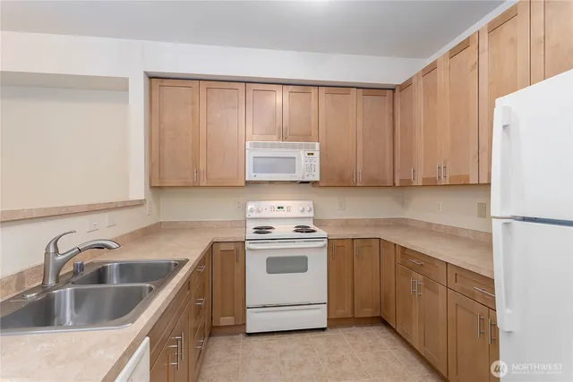 a kitchen with a sink stove and refrigerator