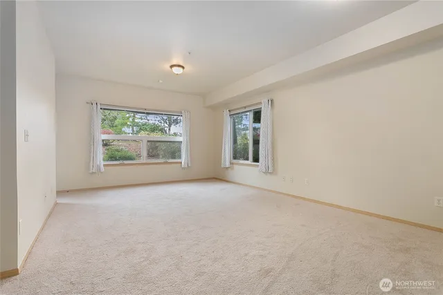 an empty room with windows and closet