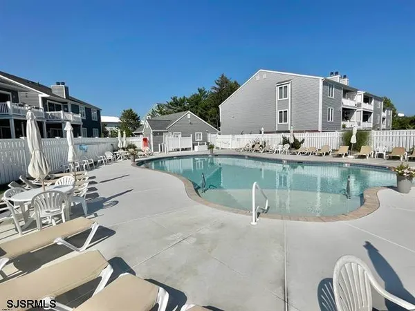 a swimming pool with outdoor seating and yard