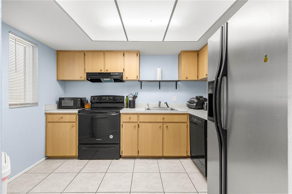 588 Fairways Lane, Unit E201 Ocala, FL 34472 - Photo 11 of 33 a kitchen with a sink cabinets and appliances