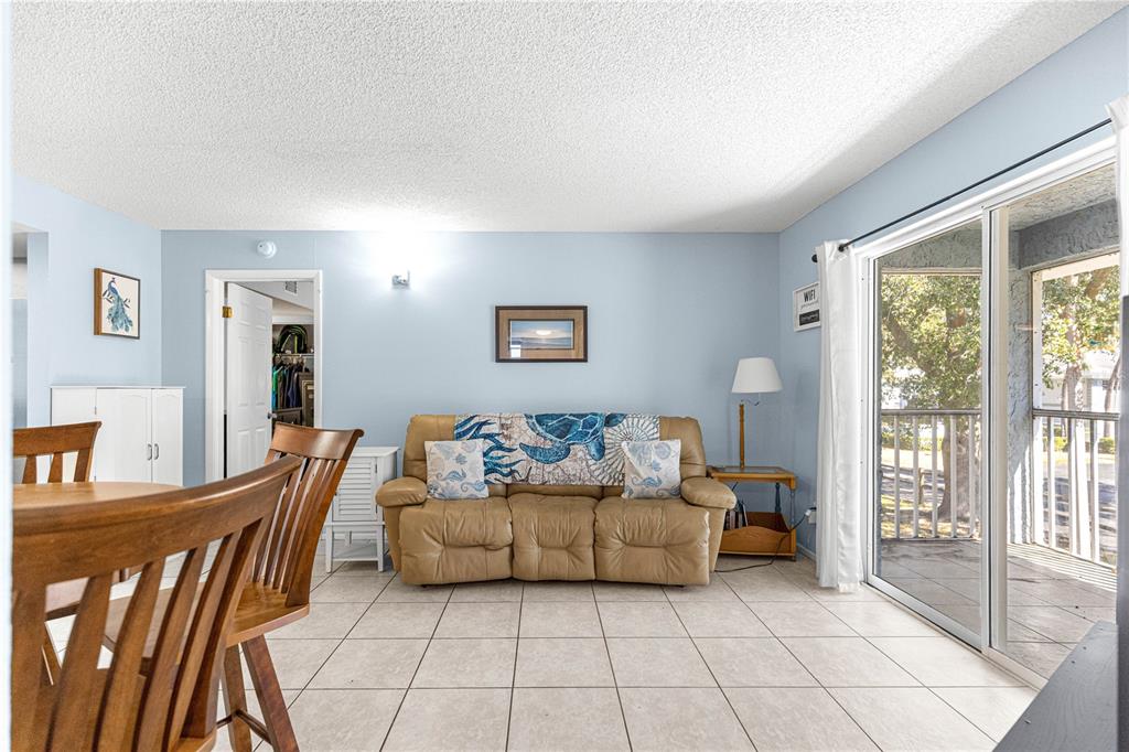 588 Fairways Lane, Unit E201 Ocala, FL 34472 - Photo 12 of 33 a living room with furniture and a floor to ceiling window