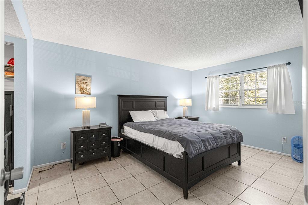 588 Fairways Lane, Unit E201 Ocala, FL 34472 - Photo 13 of 33 a bedroom with a bed and window
