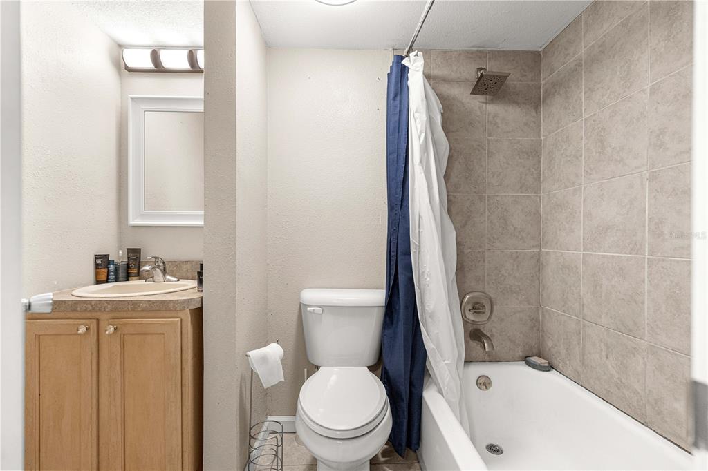 588 Fairways Lane, Unit E201 Ocala, FL 34472 - Photo 16 of 33 a white toilet sitting next to a bathroom sink