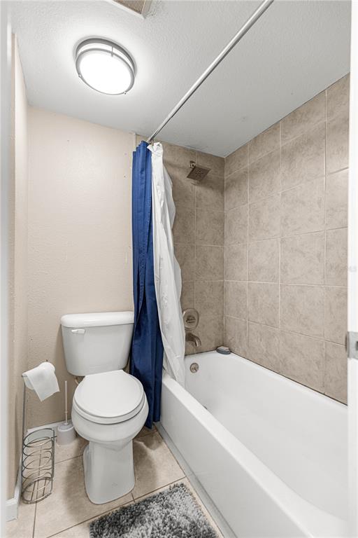 588 Fairways Lane, Unit E201 Ocala, FL 34472 - Photo 17 of 33 a white toilet sitting next to a bath tub and a shower