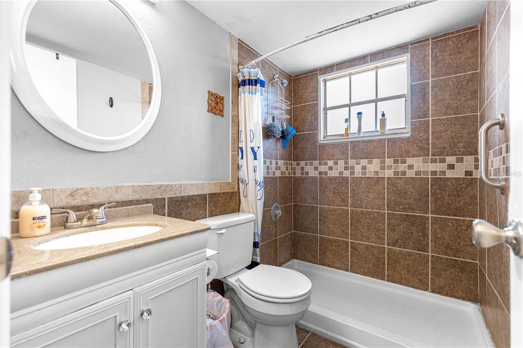 588 Fairways Lane, Unit E201 Ocala, FL 34472 - Photo 20 of 33 a bathroom with a sink a toilet and a mirror