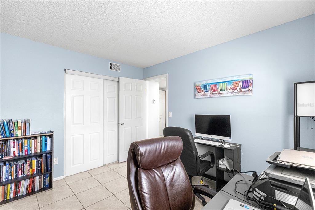 588 Fairways Lane, Unit E201 Ocala, FL 34472 - Photo 28 of 33 a view of a workspace with furniture and a bookshelf