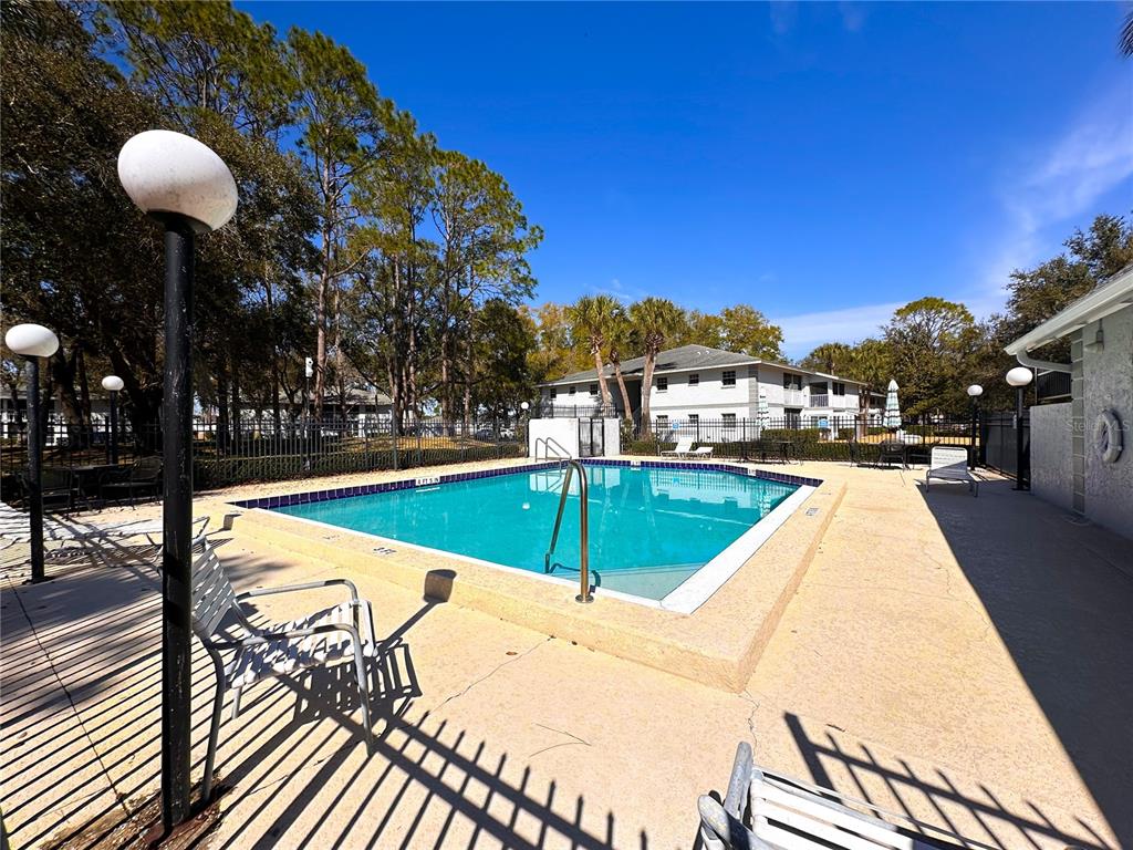 588 Fairways Lane, Unit E201 Ocala, FL 34472 - Photo 33 of 33 a view of a swimming pool with a lounge chairs