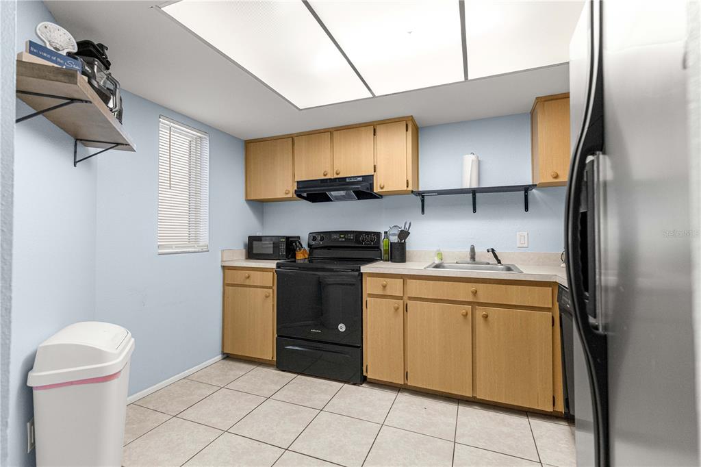 588 Fairways Lane, Unit E201 Ocala, FL 34472 - Photo 9 of 33 a kitchen with stainless steel appliances granite countertop a refrigerator sink and stove