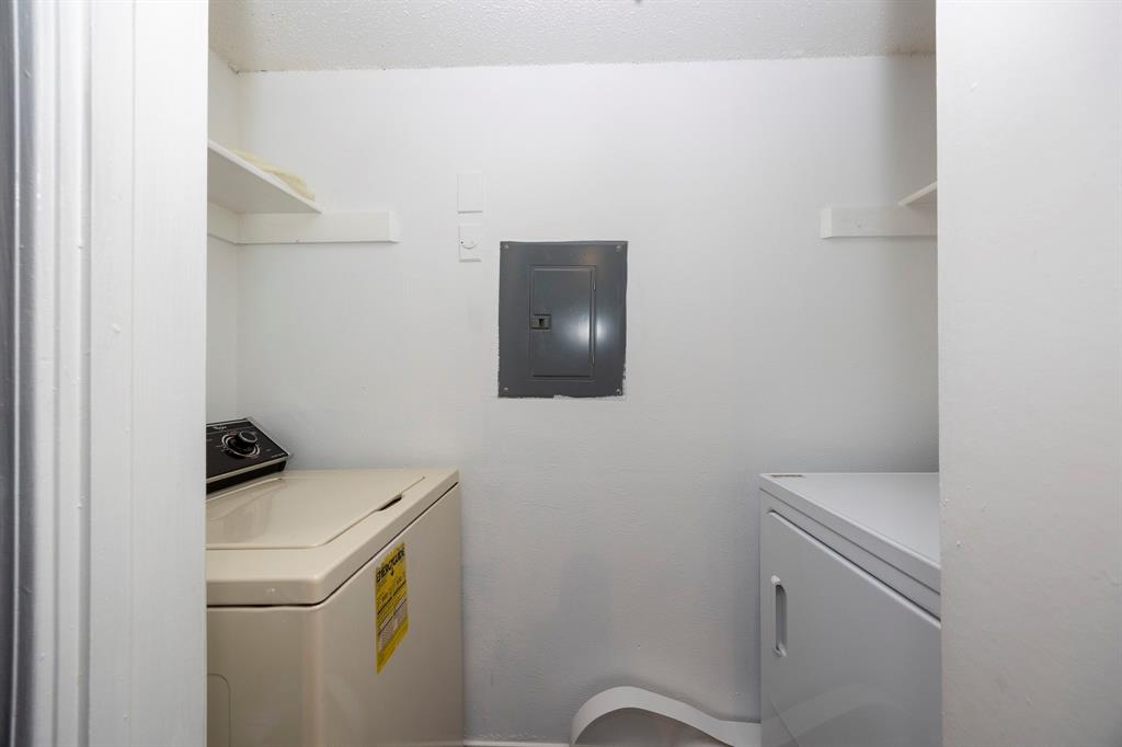 18333 Roehampton Drive, Unit 825 Dallas, TX 75252 - Photo 11 of 23 Utility area featuring wall shelving and a circuit breaker panel