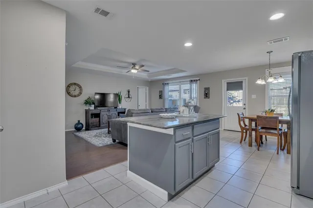 a kitchen with lots of counter top space and dining table