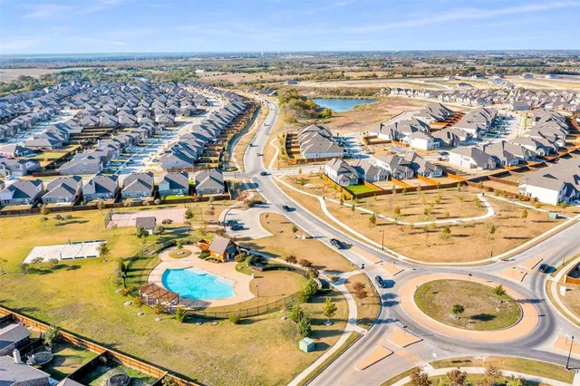 an aerial view of a swimming pool with outdoor seating