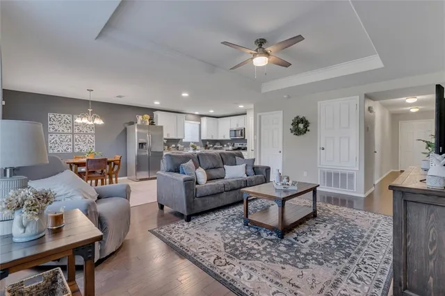 a living room with furniture and a chandelier