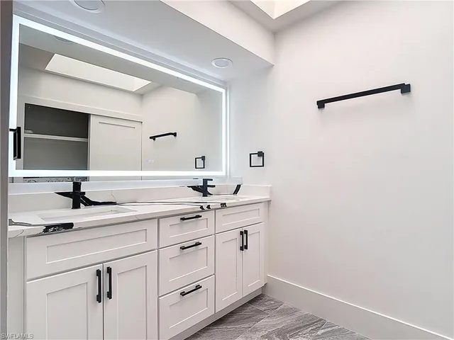 a utility room with cabinets washer and dryer