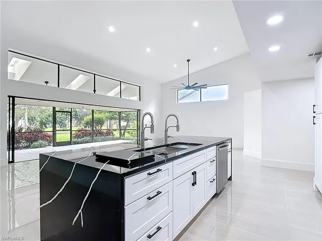 a kitchen with stainless steel appliances granite countertop a sink and a stove
