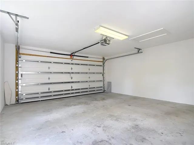 a view of a room with rack and a ceiling fan