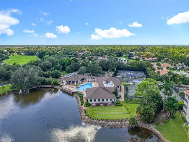 an aerial view of a house with a garden and lake view