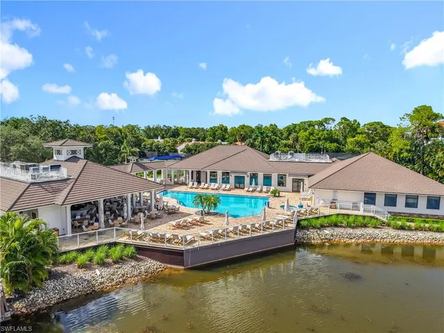 a front view of house with yard and swimming pool