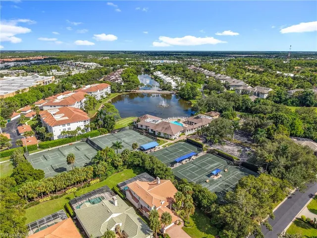 an aerial view of a city with lots of residential buildings and lake view