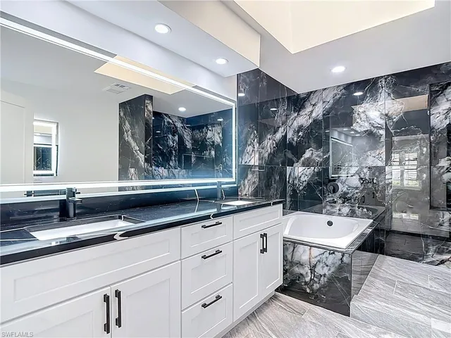 a bathroom with a sink and a large mirror