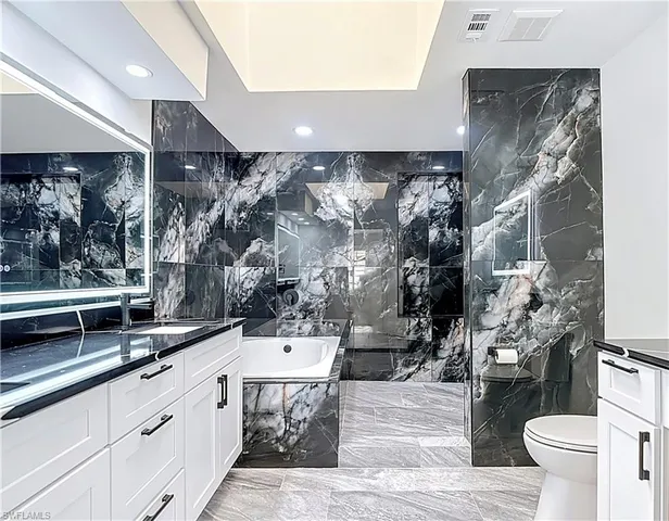 a bathroom with a sink and mirror