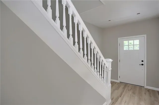 a view of an entryway with wooden floor