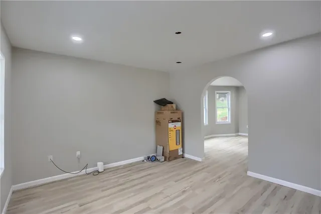 a view of a livingroom with wooden floor and a window