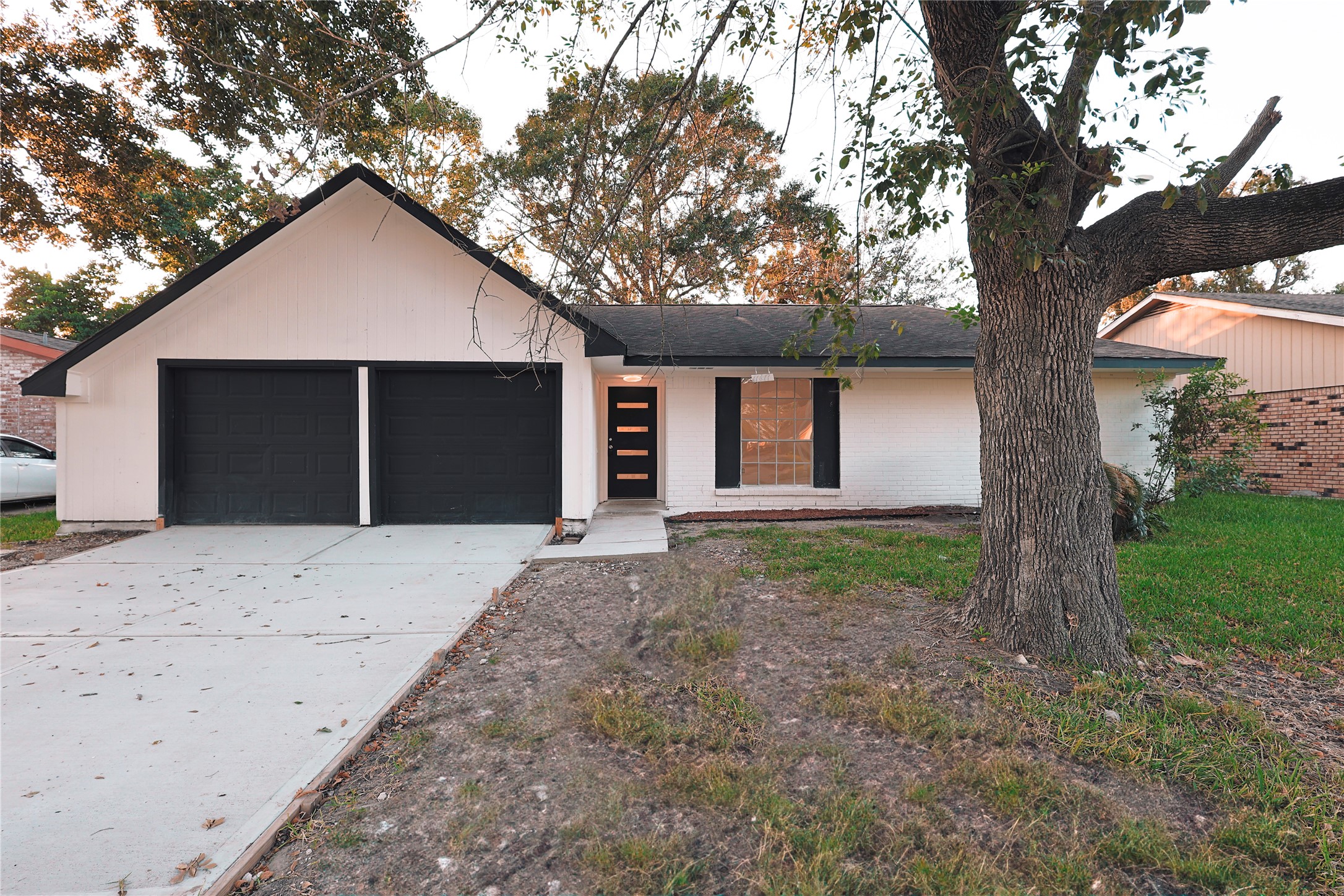 a front view of house with yard and trees