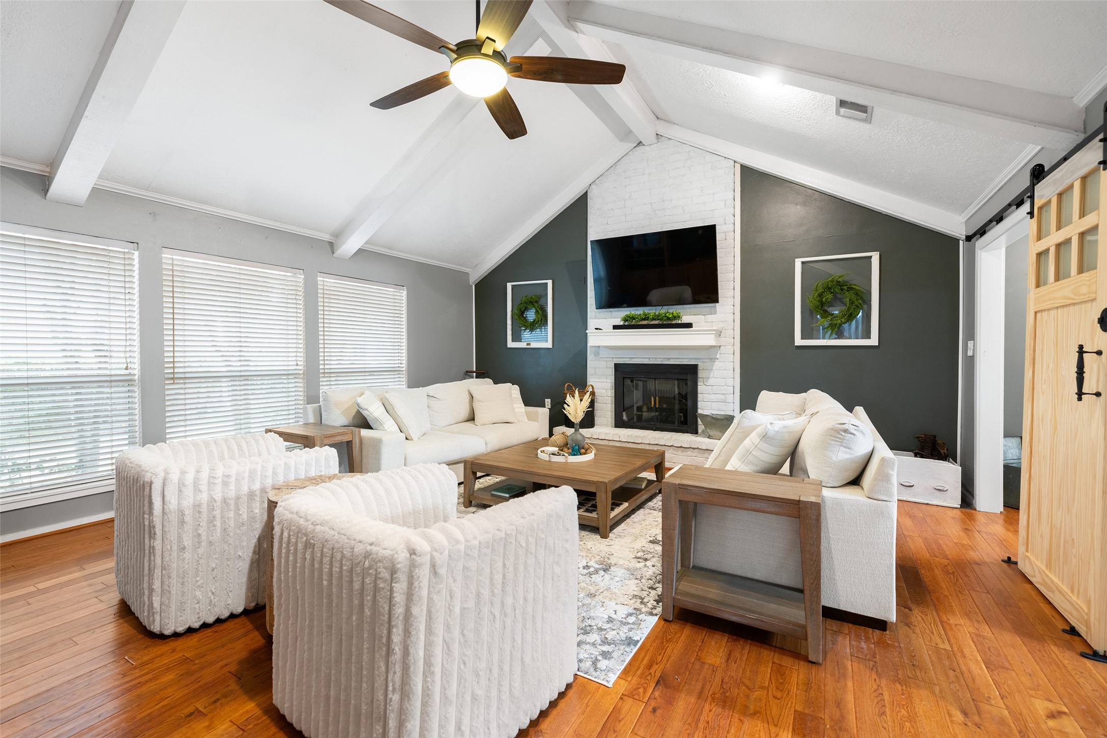a living room with furniture fireplace and a flat screen tv
