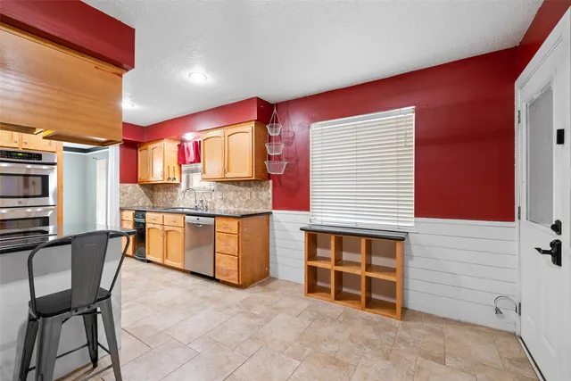 a bathroom with a granite countertop sink and mirror