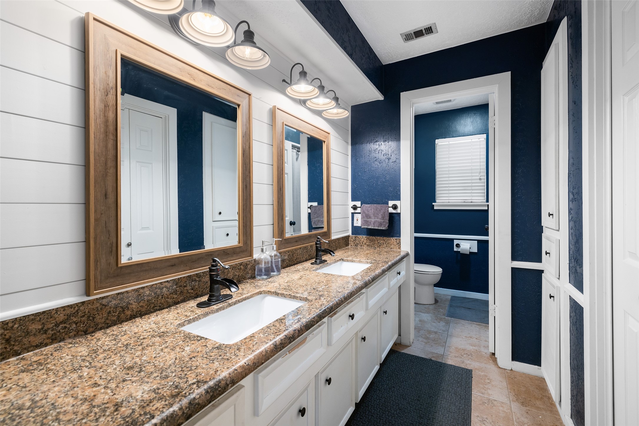 6702 Seinfeld Court Houston, TX 77069 - Photo 23 of 38 a bathroom with a granite countertop sink and a mirror