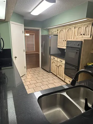 a kitchen with a refrigerator and a sink
