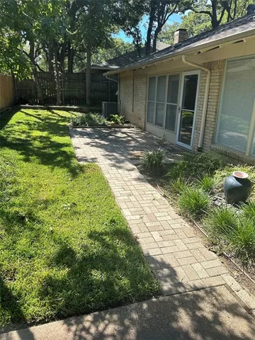 a backyard of a house with yard and outdoor seating