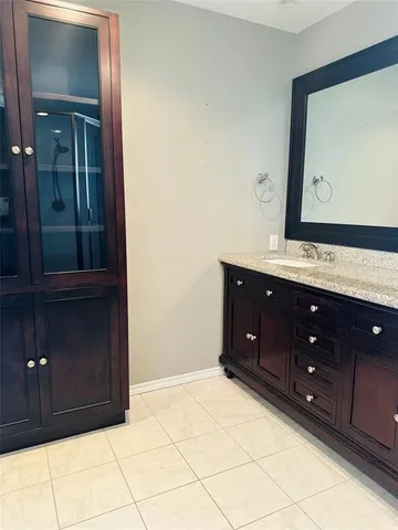 a bathroom with a sink vanity and mirror