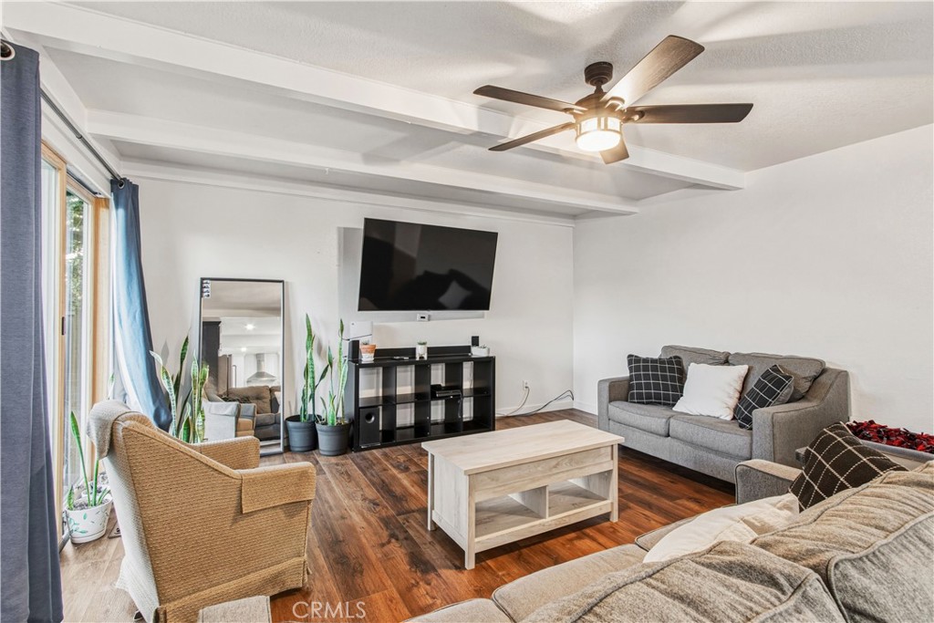 1908 Chelwood Way Modesto, CA 95355 - Photo 20 of 44 a living room with furniture a ceiling fan and a flat screen tv