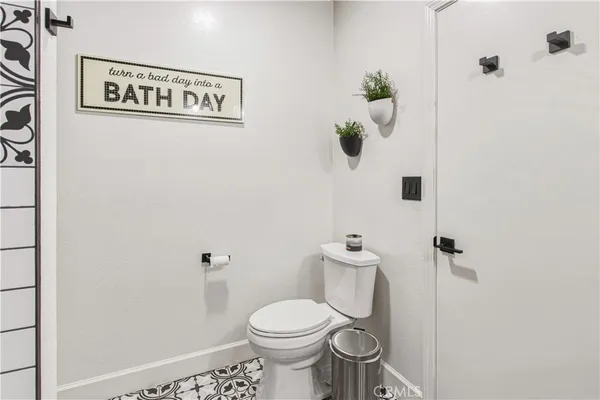 a white toilet sitting next to a shower