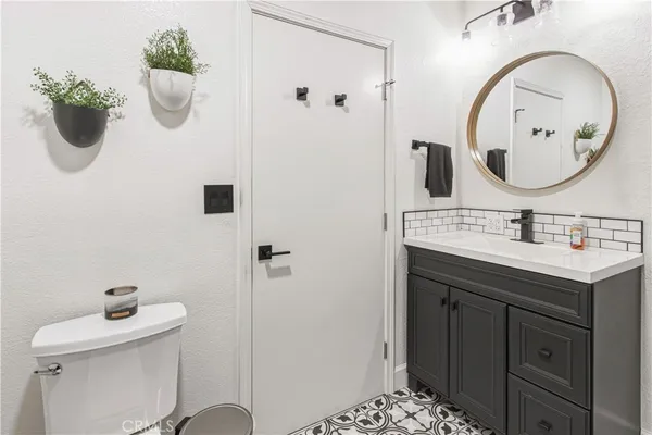 a bathroom with a toilet sink and mirror