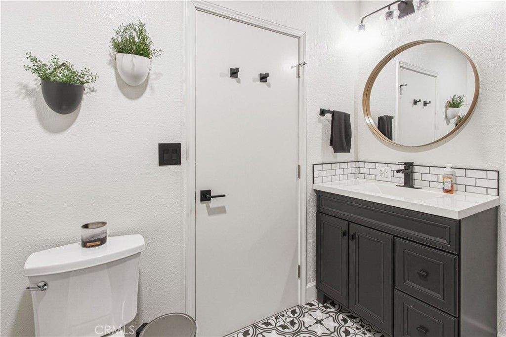 1908 Chelwood Way Modesto, CA 95355 - Photo 24 of 44 a bathroom with a toilet sink and mirror