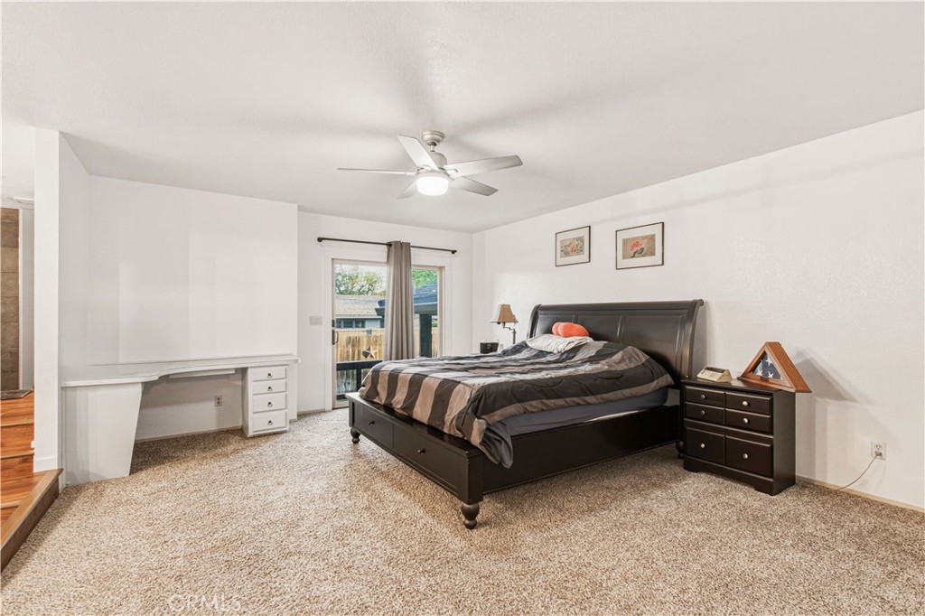 1908 Chelwood Way Modesto, CA 95355 - Photo 26 of 44 a spacious bedroom with a bed and a chandelier