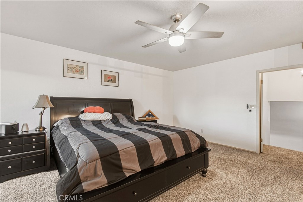 1908 Chelwood Way Modesto, CA 95355 - Photo 28 of 44 a bedroom with a bed and a chandelier