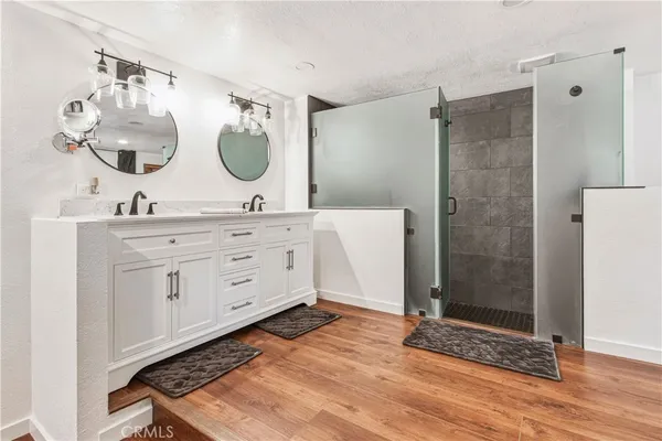 a white toilet sitting next to a shower