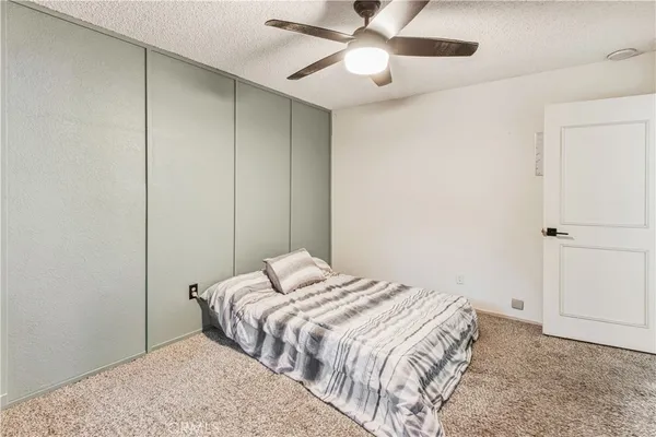 a view of a room with closet and a ceiling fan