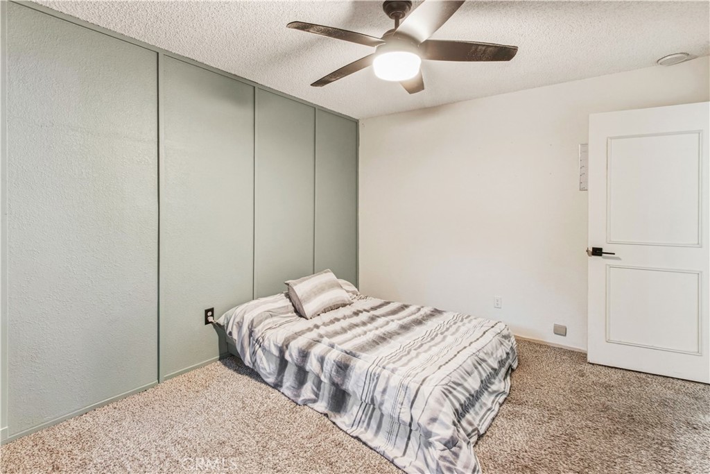 1908 Chelwood Way Modesto, CA 95355 - Photo 39 of 44 a bedroom with a bed and a ceiling fan