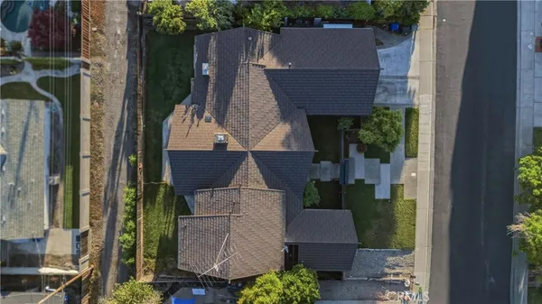 an aerial view of a house with a yard