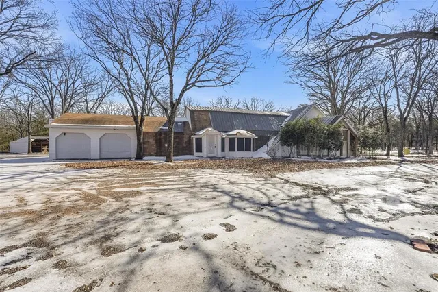a house view with snow on the road