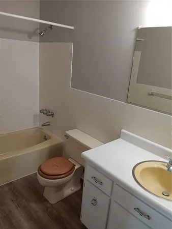 a bathroom with a toilet a sink and bathtub
