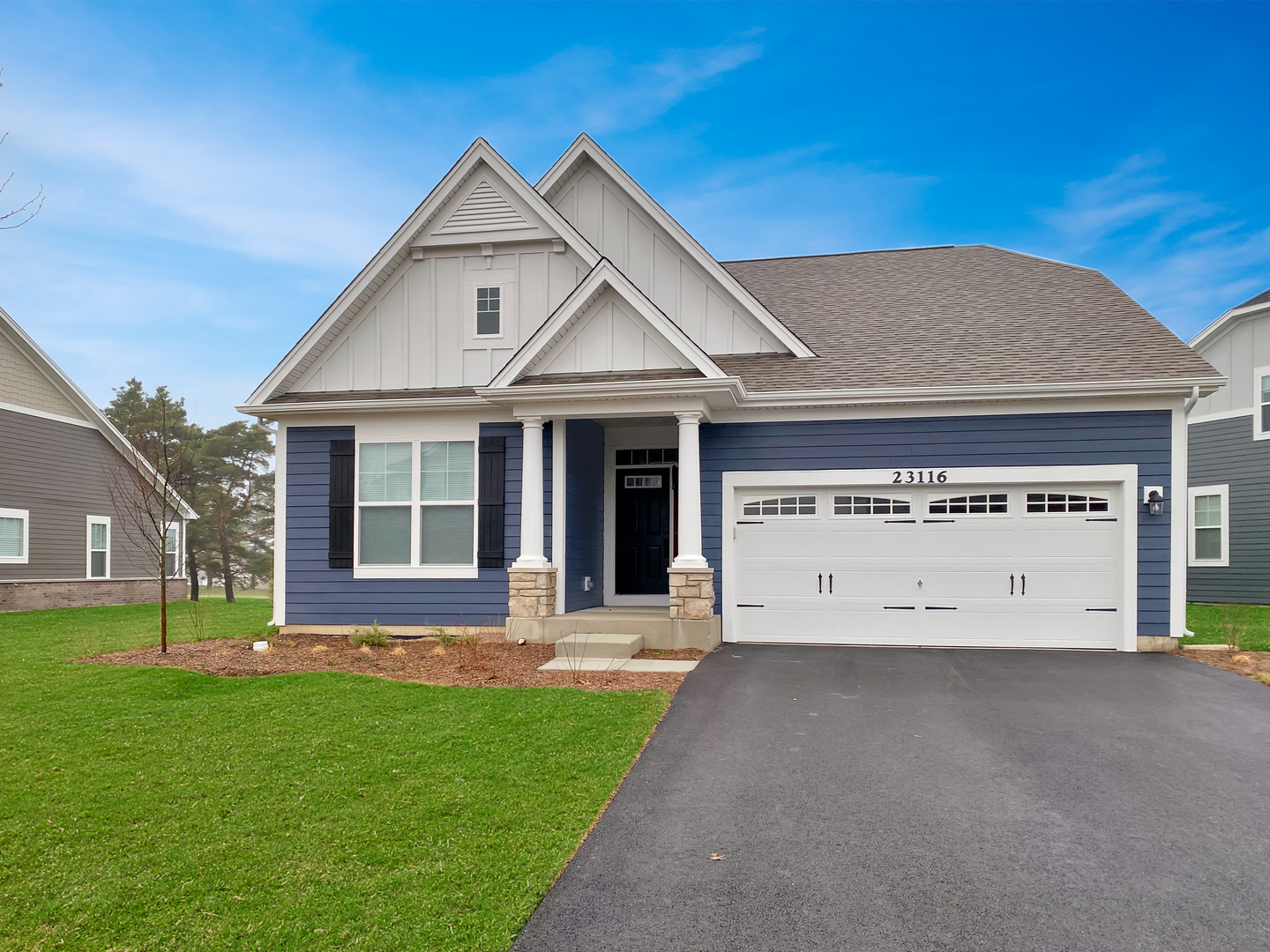 a front view of a house with a garden and yard