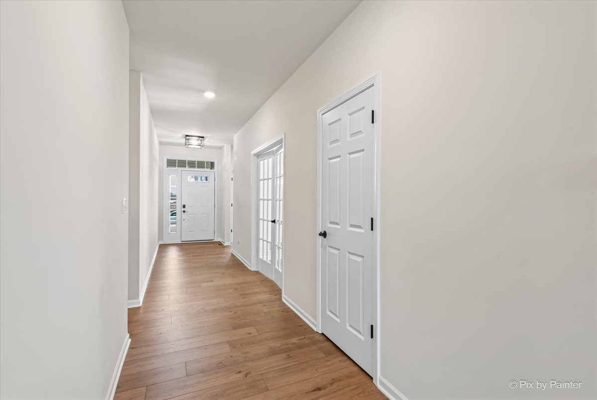 23116 Pinehurst Drive Kildeer, IL 60047 - Photo 13 of 27 a view of a hallway with wooden floor