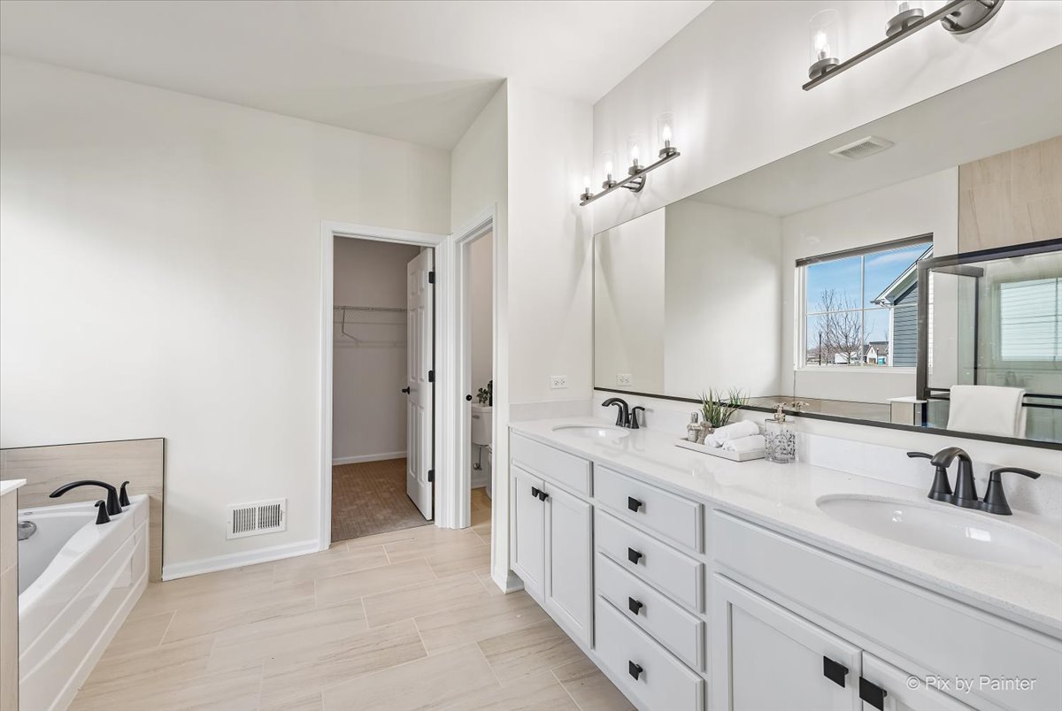 23116 Pinehurst Drive Kildeer, IL 60047 - Photo 16 of 27 a spacious bathroom with a double vanity sink double and mirror