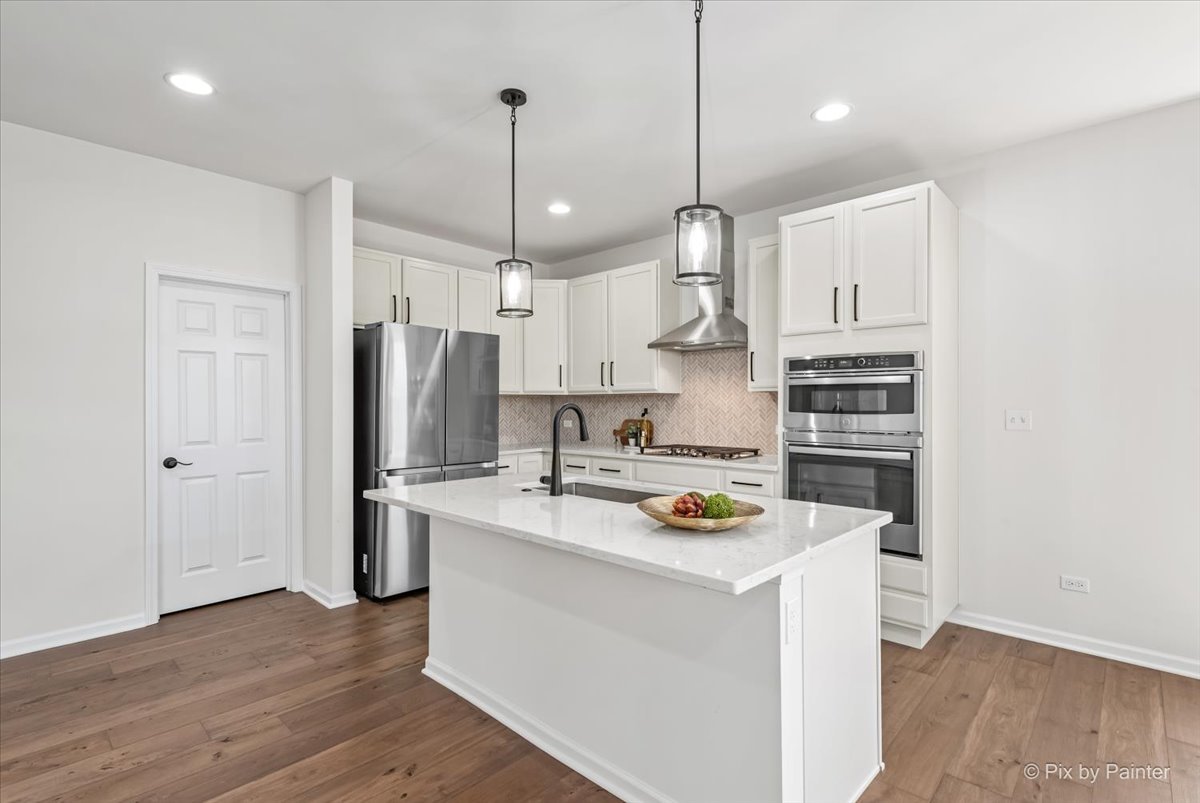 23116 Pinehurst Drive Kildeer, IL 60047 - Photo 4 of 27 a kitchen with a refrigerator a white stove top oven a sink and a center island