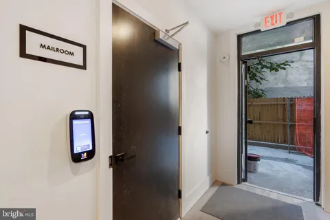 a view of a door with a door and wooden stairs